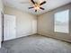 Bright bedroom with carpet flooring, a ceiling fan, and a window providing natural light at 2376 Home Again Rd, Apopka, FL 32712