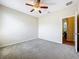 Neutral bedroom with carpet flooring, a ceiling fan, and an open door leading to another room at 2376 Home Again Rd, Apopka, FL 32712