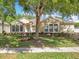 Charming single-story home with a well-manicured lawn, mature tree, and beautiful landscaping at 2376 Home Again Rd, Apopka, FL 32712