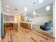 Open-concept living and kitchen area featuring modern lighting, floors, and stainless appliances at 2376 Home Again Rd, Apopka, FL 32712