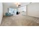 Spacious living area with large windows, neutral carpet, ceiling fan, and comfortable seating at 2376 Home Again Rd, Apopka, FL 32712