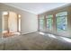 Open living room with an archway, plush carpeting, and large windows offering abundant natural light at 2376 Home Again Rd, Apopka, FL 32712
