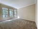 Bright living room featuring neutral walls, carpet flooring, and large windows offering natural light at 2376 Home Again Rd, Apopka, FL 32712