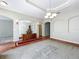 Spacious living room with tray ceiling, elegant chandelier, arched doorway, and neutral color palette at 2376 Home Again Rd, Apopka, FL 32712