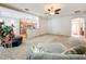 Open living area with kitchen, with ceiling fan, comfortable seating, and carpet at 2376 Home Again Rd, Apopka, FL 32712