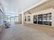Well-lit sunroom with neutral carpet, ceiling fan, and sliding doors to the outside at 2376 Home Again Rd, Apopka, FL 32712