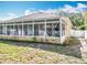 Enclosed sunroom with white framed windows, offering plenty of natural light and outdoor views at 2376 Home Again Rd, Apopka, FL 32712