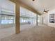 Expansive sunroom boasts neutral carpet, ceiling fan, and large windows at 2376 Home Again Rd, Apopka, FL 32712