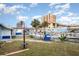 Exterior shot of a coastal home with a well-manicured lawn, palm trees, and a pool, showcasing its curb appeal at 370 Hartford Ave, Daytona Beach, FL 32118
