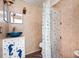 Unique bathroom featuring a blue glass vessel sink, seashell decor, and a shower with a nautical-themed curtain at 370 Hartford Ave, Daytona Beach, FL 32118