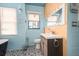 Bright bathroom with vintage style elements, updated fixtures, and a black and white patterned floor at 370 Hartford Ave, Daytona Beach, FL 32118