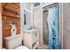 Cozy bathroom featuring a tiled shower, vanity with a vessel sink, wood shelf and coastal decorations at 370 Hartford Ave, Daytona Beach, FL 32118