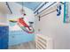 Nautical themed room featuring a mermaid wall decor, white beadboard walls and a whimsical blue painted ceiling at 370 Hartford Ave, Daytona Beach, FL 32118