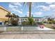 Charming beach house with white picket fence, blue trim, and lush tropical landscaping at 370 Hartford Ave, Daytona Beach, FL 32118