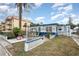 Quaint beach home featuring colorful blue trim, a garden, and a cozy outdoor seating area at 370 Hartford Ave, Daytona Beach, FL 32118