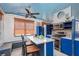 Eat-in kitchen features an island, stainless appliances, blue cabinets, and a blue ceiling at 370 Hartford Ave, Daytona Beach, FL 32118