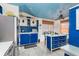 Bright blue kitchen with an island, stainless steel appliances, and a blue ceiling at 370 Hartford Ave, Daytona Beach, FL 32118