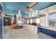 Open-concept living room with blue ceiling, nautical decor, fireplace, and vintage-style ceiling fan at 370 Hartford Ave, Daytona Beach, FL 32118