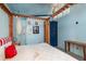 The sunlit main bedroom features blue walls, canopy bed, and nautical accents at 370 Hartford Ave, Daytona Beach, FL 32118