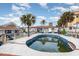 Outdoor pool area features a swimming pool surrounded by a wooden deck and tropical landscaping at 370 Hartford Ave, Daytona Beach, FL 32118