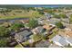 Aerial view of a lakeside neighborhood with a mix of home styles and lush greenery at 4133 Staffordshire Dr, Lakeland, FL 33809