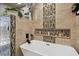 Stylish bathtub with modern fixtures, unique tile, and niche shelving with candles at 4133 Staffordshire Dr, Lakeland, FL 33809