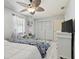 Comfortable bedroom with ceiling fan, shuttered closet, dresser, and beach-themed decor at 4133 Staffordshire Dr, Lakeland, FL 33809