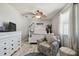 Bright bedroom featuring a ceiling fan, hardwood floors, beachy accents, and natural light at 4133 Staffordshire Dr, Lakeland, FL 33809