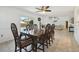 Inviting dining area adjacent to the living room, featuring a classic wood table and backyard views at 4133 Staffordshire Dr, Lakeland, FL 33809