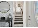 Inviting entryway with modern decor elements, leading to an open staircase at 4133 Staffordshire Dr, Lakeland, FL 33809