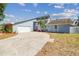 Exterior of home featuring light blue siding, front yard landscaping, and a long concrete driveway at 4133 Staffordshire Dr, Lakeland, FL 33809