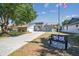 Landscaped front yard featuring a bench and blue home with a long driveway at 4133 Staffordshire Dr, Lakeland, FL 33809