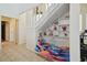 Unique under-stairs space featuring a cute dog bed and decorative shelving, adding character to the hallway at 4133 Staffordshire Dr, Lakeland, FL 33809