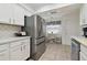 Updated kitchen featuring stainless steel refrigerator and breakfast nook with decorative window treatment at 4133 Staffordshire Dr, Lakeland, FL 33809