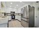 Modern kitchen with stainless steel appliances, white cabinetry, and ample counter space for cooking and entertaining at 4133 Staffordshire Dr, Lakeland, FL 33809