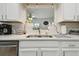 Close-up of the kitchen sink featuring white countertops and decorative backsplash and sink decor at 4133 Staffordshire Dr, Lakeland, FL 33809