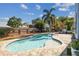 In-ground pool surrounded by brick pavers, landscaping and a wood privacy fence at 4133 Staffordshire Dr, Lakeland, FL 33809