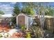 A backyard shed surrounded by manicured landscaping with mulch and brick pavers at 4133 Staffordshire Dr, Lakeland, FL 33809