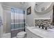 Stylish bathroom features a shower with curtain, a vanity with marble countertop, and modern fixtures at 4719 Dove Cross Dr, Lakeland, FL 33810