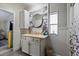 Bright bathroom featuring a round mirror, neutral-toned vanity, and updated lighting at 4719 Dove Cross Dr, Lakeland, FL 33810