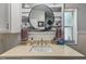 Bright bathroom featuring vanity with light countertop, round mirror, and neutral decor at 4719 Dove Cross Dr, Lakeland, FL 33810