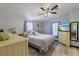 Serene bedroom with a soft color palette, ceiling fan, light wood floors, and comfortable furnishings at 4719 Dove Cross Dr, Lakeland, FL 33810