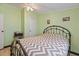 Comfortable bedroom offering a metal-frame bed, neutral chevron comforter and ceiling fan at 4719 Dove Cross Dr, Lakeland, FL 33810