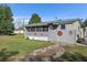 Exterior home view with a green metal roof, stars, privacy fence, and a green lawn at 4719 Dove Cross Dr, Lakeland, FL 33810
