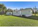 Charming single-story home and shed surrounded by a well-maintained lawn and mature trees at 4719 Dove Cross Dr, Lakeland, FL 33810