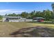 Spacious front yard featuring a single-story home with a covered carport and lush green lawn at 4719 Dove Cross Dr, Lakeland, FL 33810