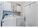 Efficient laundry area with modern washer and dryer, and overhead cabinets for storage solutions at 4719 Dove Cross Dr, Lakeland, FL 33810