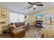 Comfortable living room featuring a plush sofa, a fireplace, and a modern TV for cozy relaxation at 4719 Dove Cross Dr, Lakeland, FL 33810