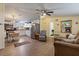 Open-concept living area with wood laminate floors, leading into the kitchen with white cabinets and modern appliances at 4719 Dove Cross Dr, Lakeland, FL 33810