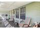 Inviting porch with striped chairs, a table, and an array of plants, creating a relaxing outdoor space at 4719 Dove Cross Dr, Lakeland, FL 33810